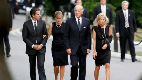 Getty Images Hunter (extreme left) walks with his then-wife Kathleen, father Joe and step-mother Jill in 2009
