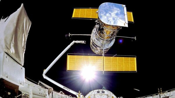 The Hubble Space Telescope against a dark background.