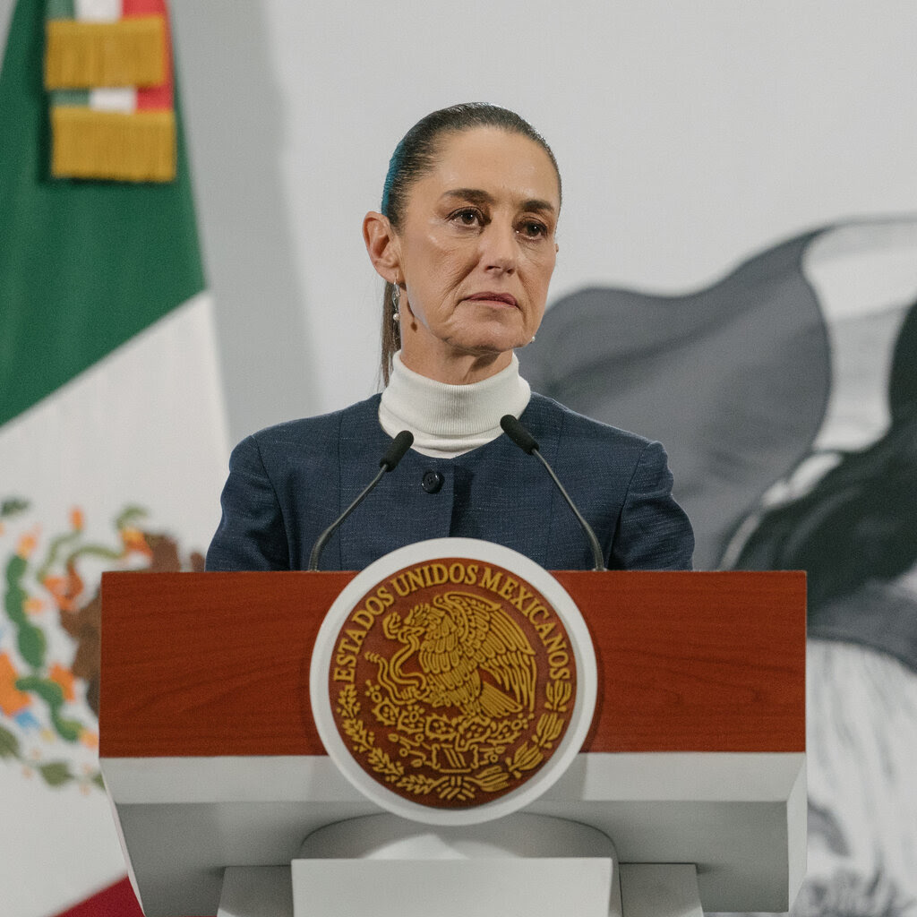 President Claudia Sheinbaum of Mexico standing behind a podium.