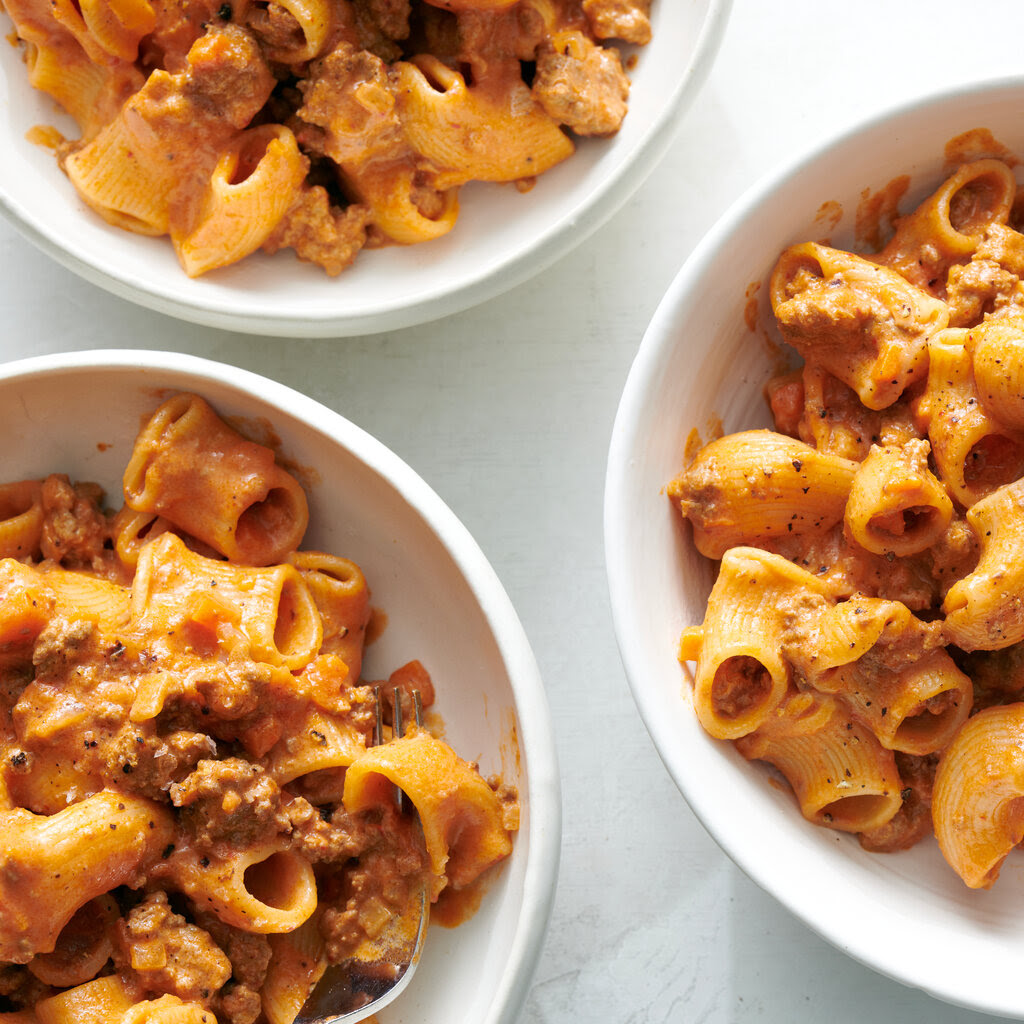 Plates of pasta in Bolognese sauce. 