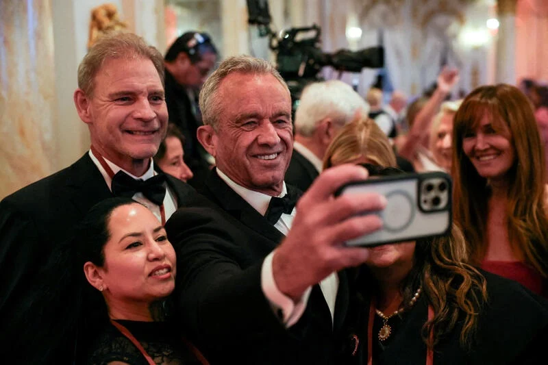 Robert F. Kennedy Jr. takes a selfie at a gala at Mar-A-Lago