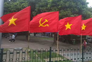 Flags of the Communist Party of Vietnam and the nation of Vietnam are flying together.