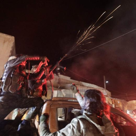 Anti-government fighters celebrate in the northern Syrian town of Tal Rifaat on December 1, 2024. The Syrian Observatory for Human Rights said pro-Turkey fighters seized a strategic northern town from Kurdish forces, in fighting parallel to a major rebel offensive elsewhere in Aleppo province. (Photo by Bakr ALKASEM / AFP)