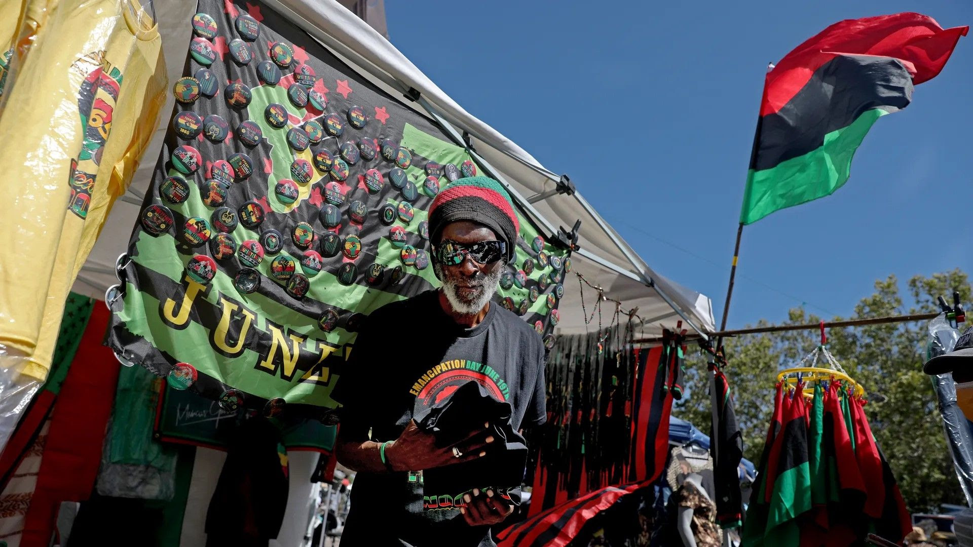 A man sells items at a Juneteenth festival.