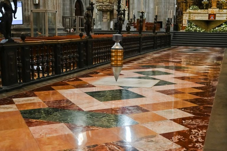 At the centre of the nave hangs a weight that tracks the cathedral’s motion across the centuries.