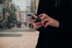 A woman is holding a cell phone.