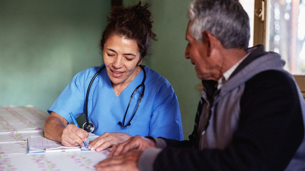 Doctor talking to a patient and writing-1