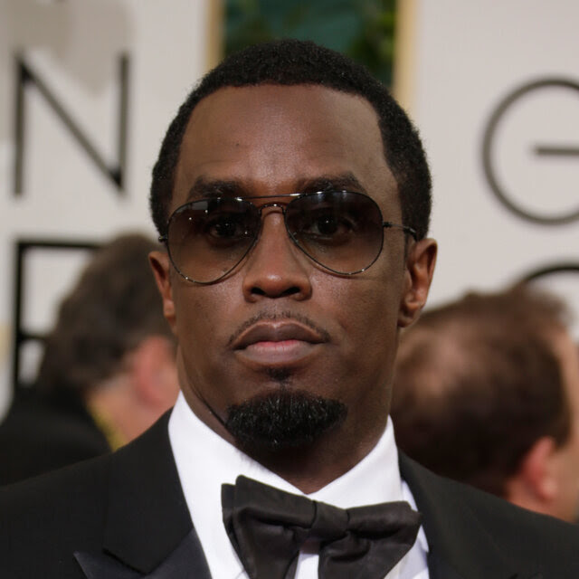 Sean Combs in a tuxedo and sunglasses.