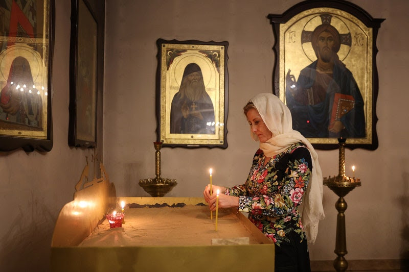 Image may contain: Ephrem the Syrian, Adult, Person, Art, Painting, Prayer, Altar, Architecture, Building, Church, and Candle