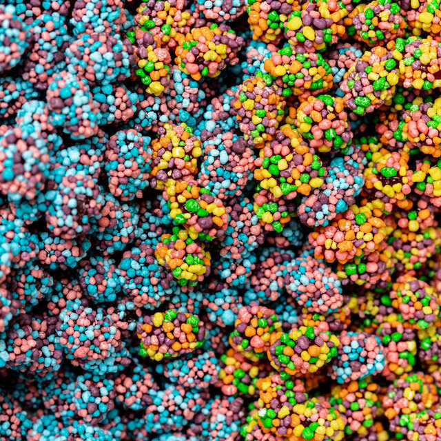 Nerds Gummy clusters, or small dime-size balls with a gummy core and colorful Nerds coating. 