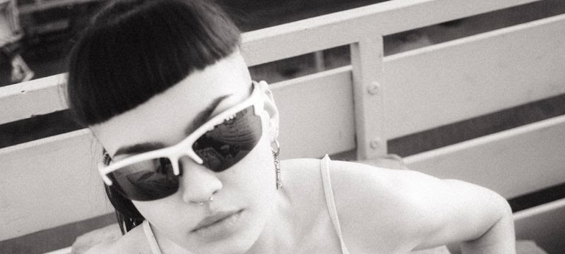 a woman with a blunt fringe wearing sunglasses