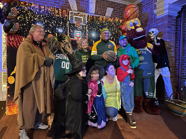 Gov. Jay Inslee and First Spouse Trudi Inslee pose for a photo with trick-or-treaters on Halloween