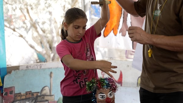 Mahdi Atiya builds puppets from the remnants of possessions among the destruction left behind by Israel's bombing of Gaza and teaches children how to operate them. Photo: Ruwaida Amer