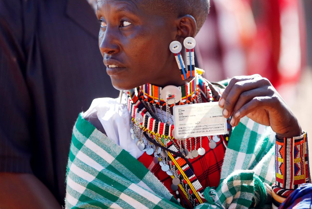A Masai woman holds her ID card near the town of Magadi some 85 km (53 miles) south of Nairobi, Kenya March 4, 2013