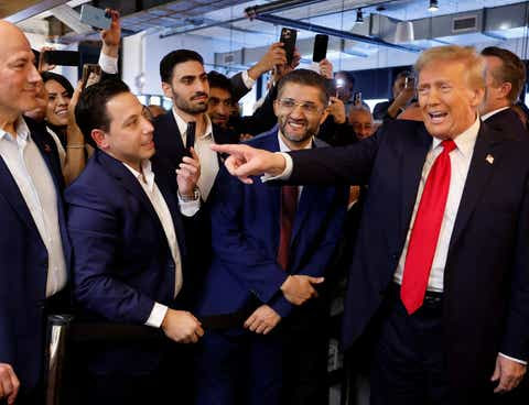 Republican presidential nominee and former President Donald Trump visits The Great Commoner cafe in Dearborn, Michigan while Hamtramck mayor Amer Ghalib stands to his right