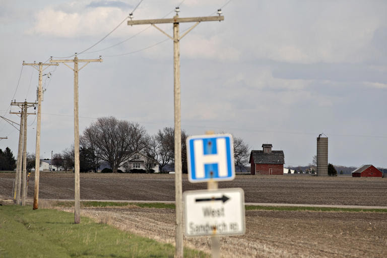 A barn stands past a road sign outside Sandwich, Ill. There are fewer counties where most people can afford and access top-notch clinical care in the southern regions than the northern and Pacific coast ones.