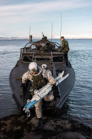 NATO’s Arctic Marines getting down from a boat, with skis