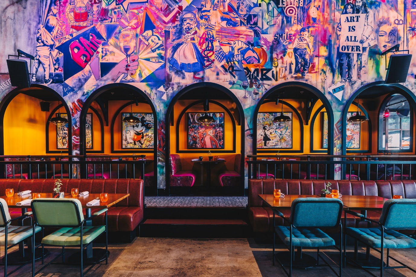 A colorful wall with art on the wallAI-generated content may be incorrect.