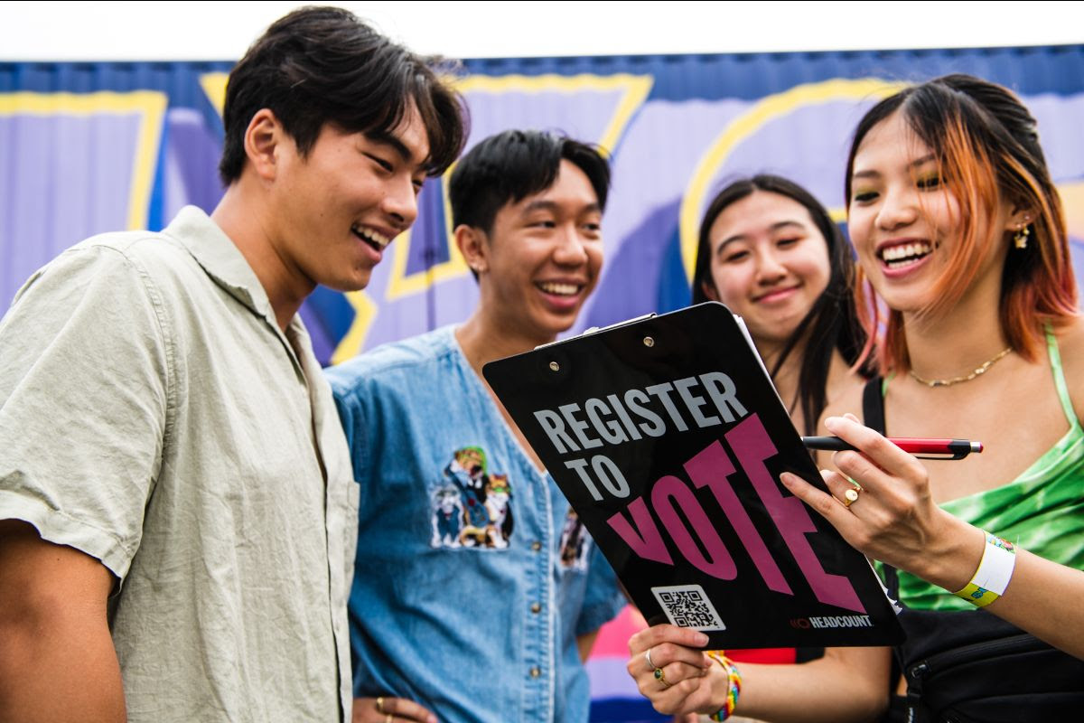 A group on young Asian people registering to vote at a HeadCount event