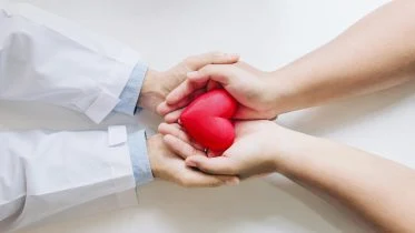 Doctor and Patient Holding Heart