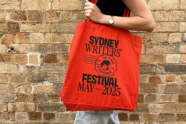 A 2025 Sydney Writers' Festival tote worn on a person's shoulder.