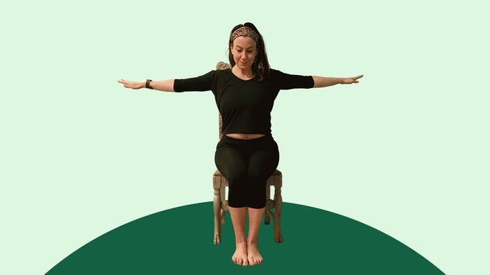 Woman doing chair yoga eagle pose on green background.