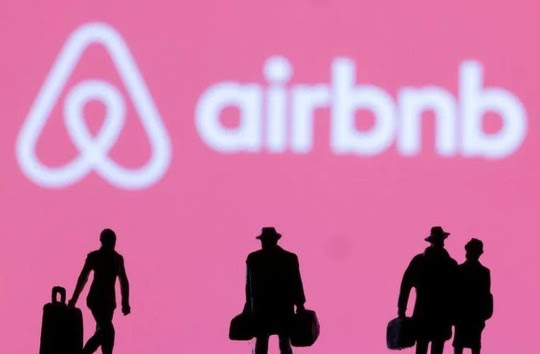  Figurines are seen in front of displayed Airbnb logo - reuters - Yahoo 