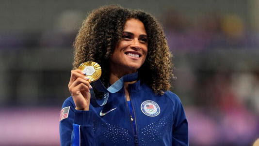 Women's 400-meter hurdles gold medalist Sydney McLaughlin-Levrone, of the United States, stands on the podium at the 2024 Summer Olympics, Friday, Aug. 9, 2024, in Saint-Denis, France.