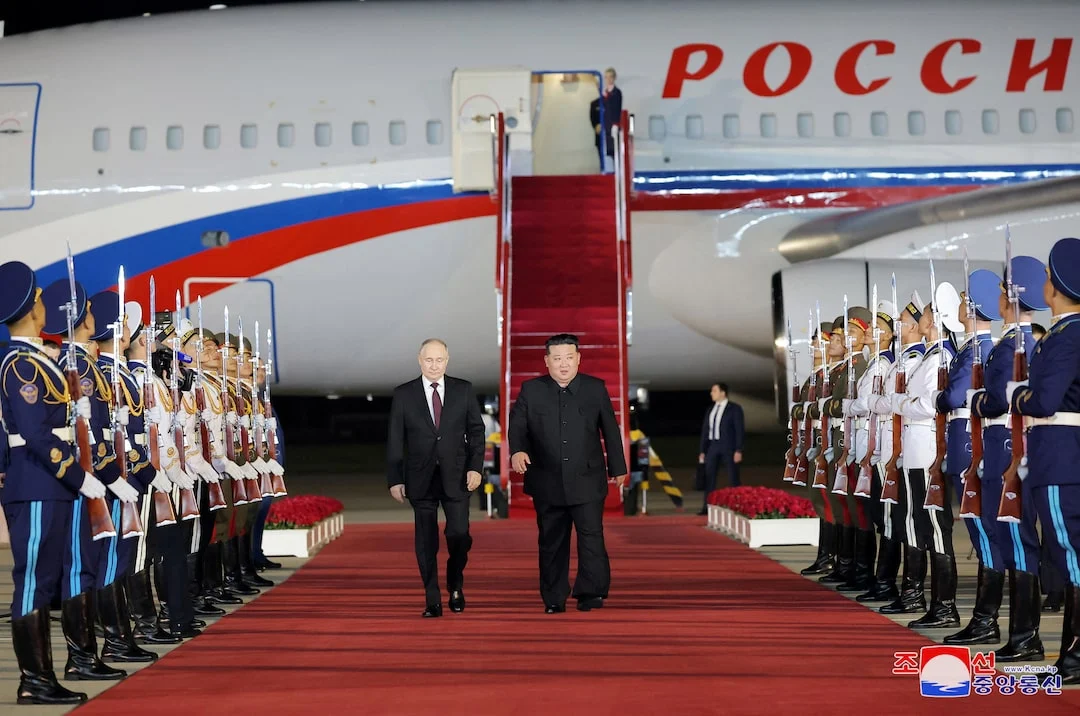 Russian President Vladimir Putin is welcomed by North Korean leader Kim Jong Un upon his arrival at an airport in Pyongyang, North Korea, in this image released by the Korean Central News Agency on June 19, 2024.