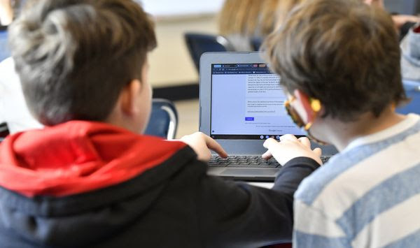 Michael Burton-Straub, left, and Declan Lewis attempt to &quot;Find the Bot&quot; in Donnie Piercey&#x27;s class at Stonewall Elementary in Lexington, Ky., Monday, Feb. 6, 2023.  Students in the class each summarized a text about boxing champion and Kentucky icon Muhammad Ali then tried to figure out which summaries were penned by classmates and which was written by the chatbot. The chatbot was the new artificial intelligence tool, ChatGPT, which can generate everything from essays and haikus to term papers in a matter of seconds. (AP Photo/Timothy D. Easley) **FILE**