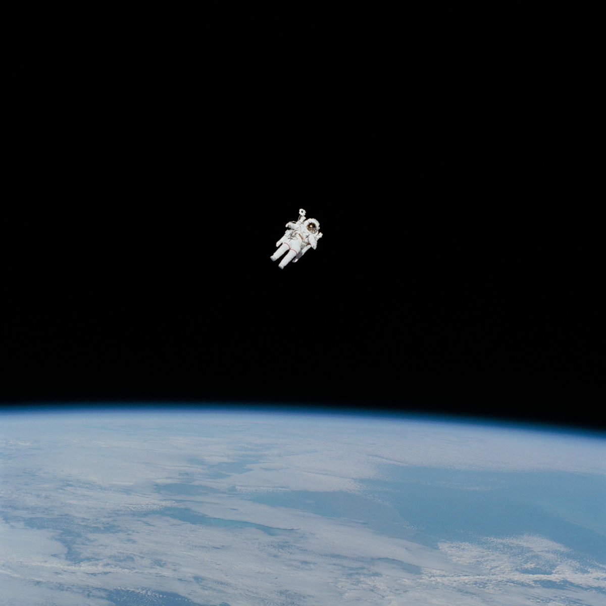 astronaut floating above Earth in space