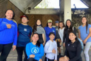 A group of Guam Sea Turtle Research Internship participants pose with three kneeling in front and 8 people standing in the back