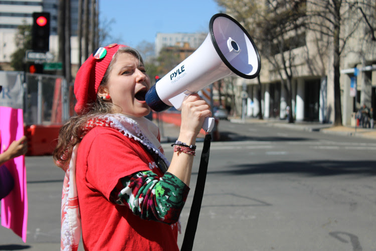 Lysandra da Silva leading the chants at the Women's Day protest.