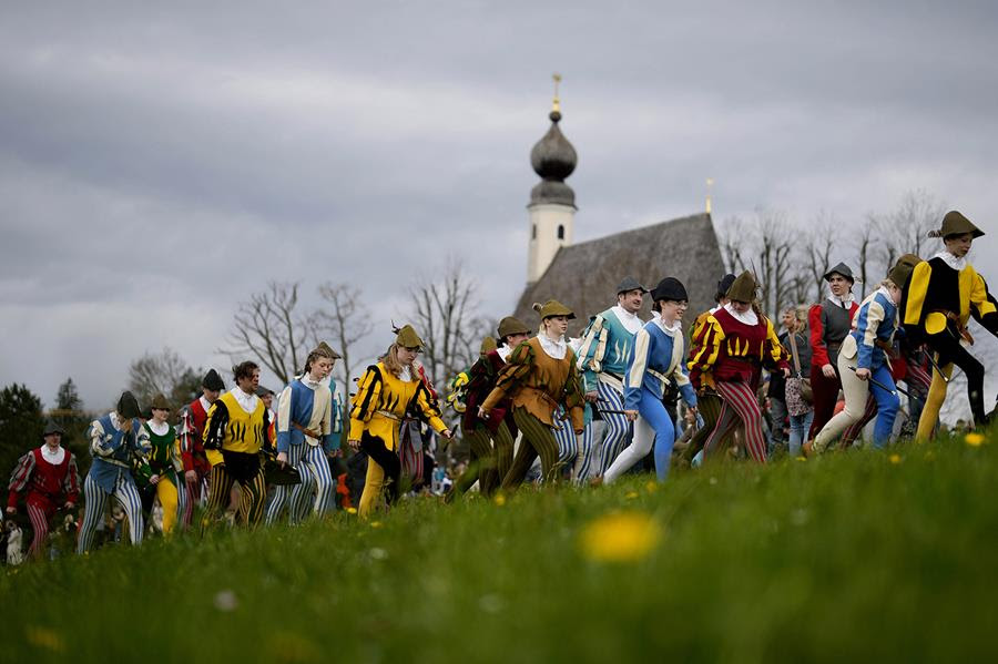 A procession of residents in Traunstein, Germany wear colorful traditional costumes.