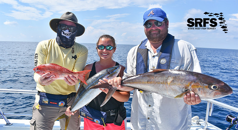 three people on a boat each holding a large fish