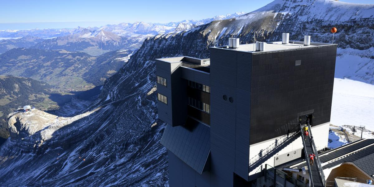 The new restaurant Botta pictured the day of the inauguration at the Glacier 3000 resort, in the Swiss Alps at an altitude of 3,000 metres (9,800 ft), in Les Diablerets, Ormont-Dessus, Thursday, November 14, 2024. After the September 2022 fire, the Glacier 3000 restaurant is being rebuilt by renowned Swiss architect Mario Botta, retaining its exterior design while reimagining the interior for a better dining experience. 600 solar panels on the southwest fa ade will enhance energy efficiency. (KEYSTONE/Laurent Gillieron)