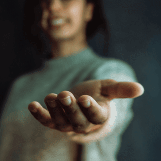 Person reaching their hand forward in support