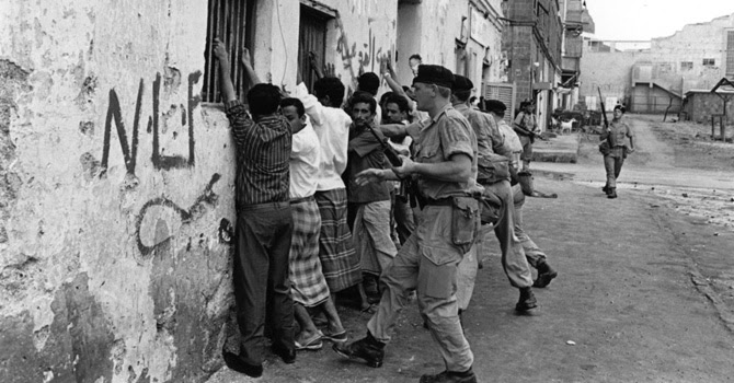 British soldiers pin National Liberation Front (NLF) sympathisers to the wall in Aden, Yemen, 1967.