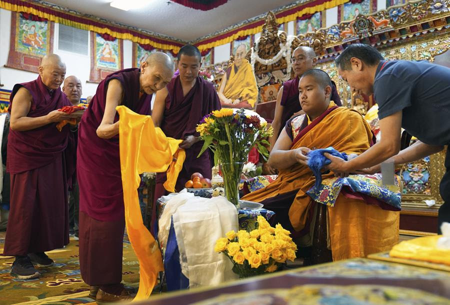 A group of people in traditional Buddhist robes.