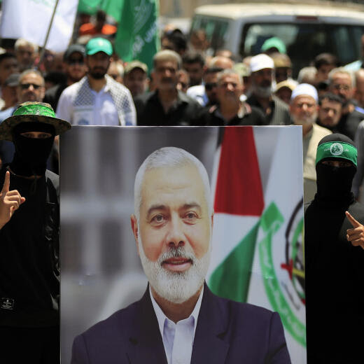 Hamas members hold a poster of Hamas political chief Ismail Haniyeh during a protest to condemn his killing, at al-Bass Palestinian refugee camp, in the southern port city of Tyre, Lebanon, Wednesday, July 31, 2024. Haniyeh, Hamas' political chief in exile who landed on Israel's hit list after the militant group staged its surprise Oct. 7 attacks, was killed in an airstrike in the Iranian capital early Wednesday. (AP Photo/Mohammed Zaatari)