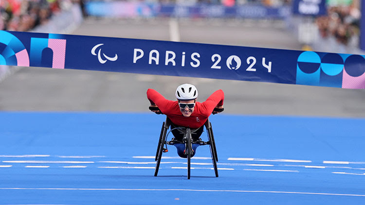 Catherine Debrunner of Team Switzerland crosses the finish line during the Women's Marathon T54 on day eleven of the Paris 2024 Paralympic Games. ©Andy Lyons/Getty Images