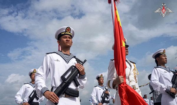 In this photo taken from video released by Russian Defense Ministry Press Service on Monday, July 15, 2024, Chinese military sailors attend a welcome ceremony of their joint naval forces exercise in Zhanjiang in Guangdong province on Sunday July 14, 2024. China and Russia&#x27;s naval forces have kicked off a joint exercise at a military port in southern China on Sunday, official news agency Xinhua reported, days after NATO allies called Beijing a &quot;decisive enabler&quot; of the war in Ukraine. China&#x27;s military is advancing the development of high-technology arms, including sound weapons to wage cognitive warfare — the use of unconventional tools and capabilities to alter enemy thinking and decision-making, according to a new open-source intelligence report. (Russian Defense Ministry Press Service via AP)