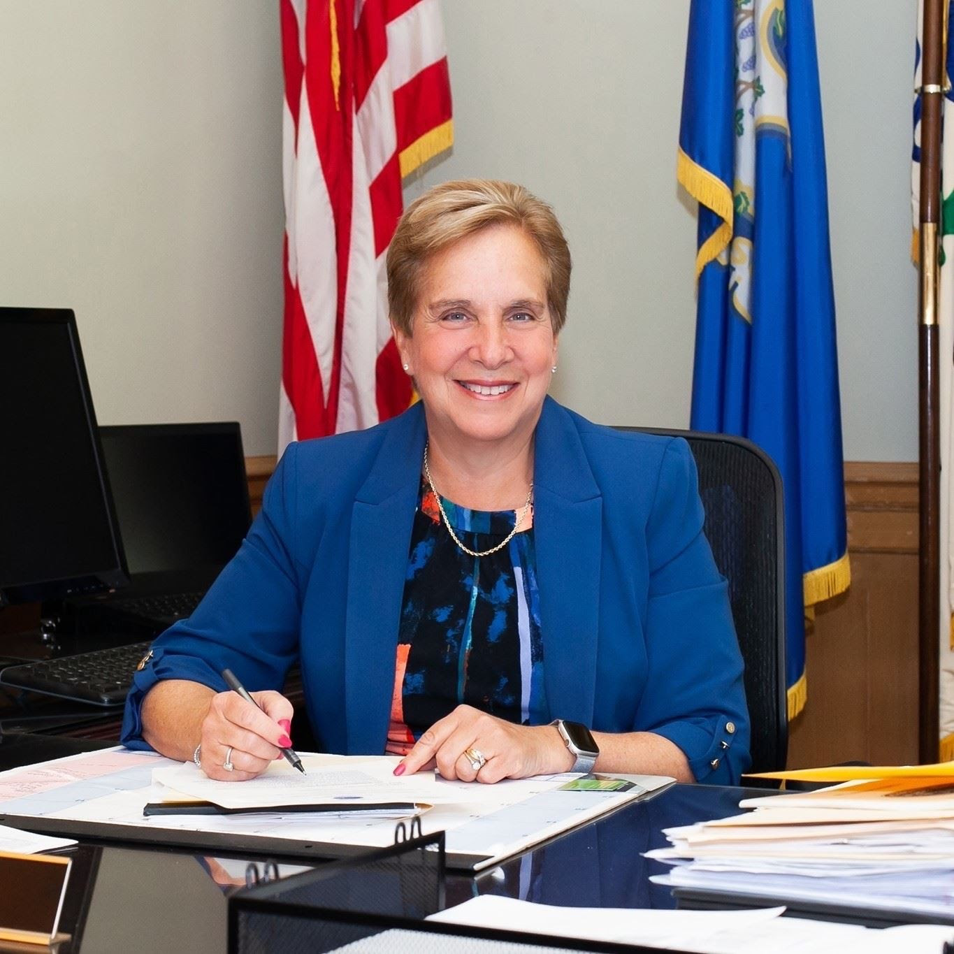 Vicki Tesoro Sitting at Desk