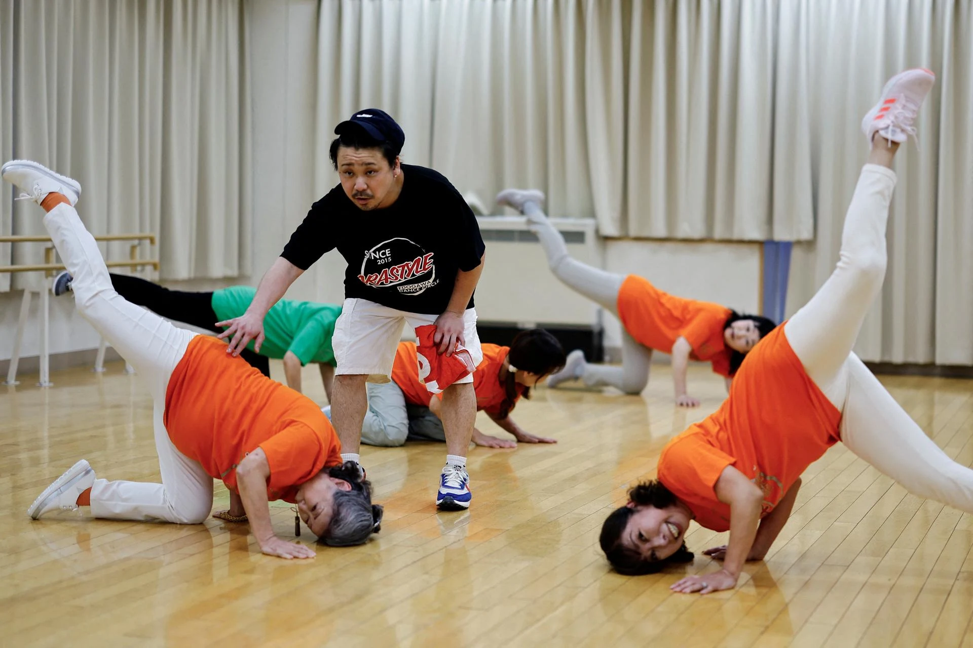 The instructor of Japan's only breakdancing club made up of elderly citizens, Ara Style Senior, coaches Saruwaka Kiyoshie and Reiko Maruyama, as they practice a dance move during a training session on April 26, 2024.