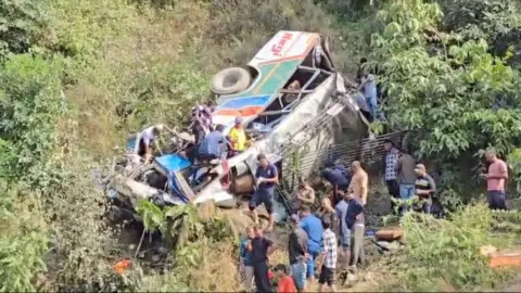 PTI Locals and SDRF officials rescue survivors after a bus falls into a gorge in India's Uttarakhand state.