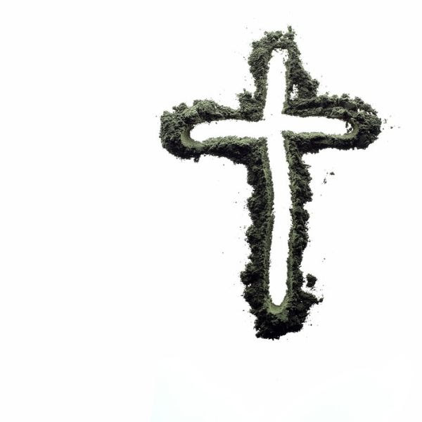 Outline of a cross in ashes on a white background