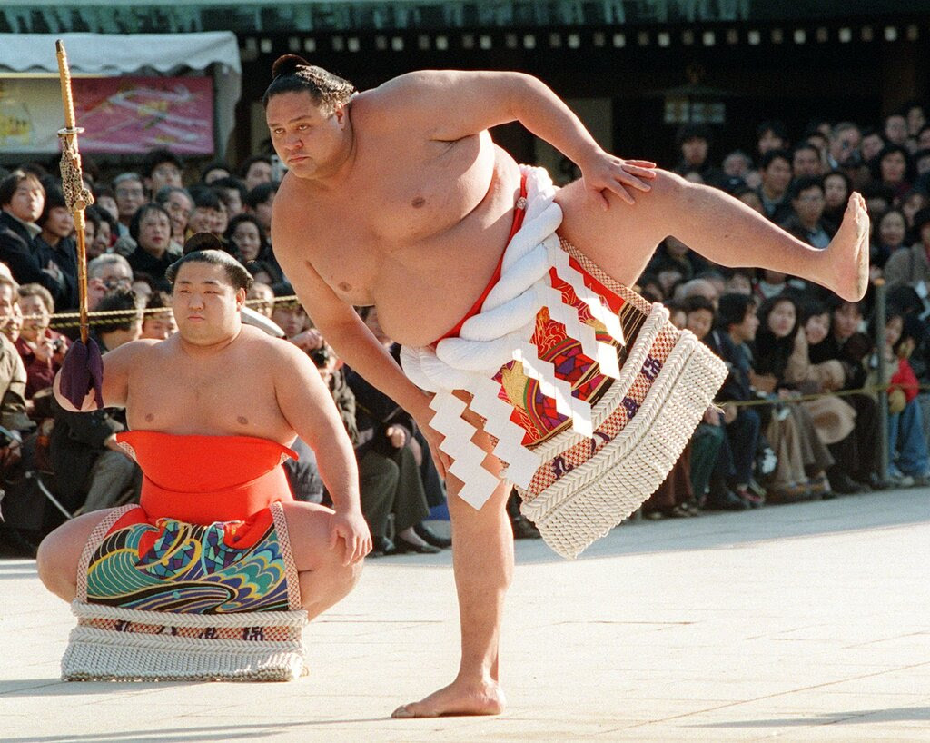 Taro Akebono performs traditional sumo stomping at a ceremony in Japan.