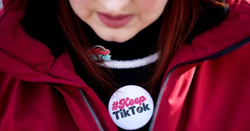 A content creator wears a %22Keep TikTok%22 button outside the US Supreme Court in Washington, DC, US, on Friday, Jan. 10, 2025. The future of the wildly popular social media platform TikTok rides on a US Supreme Court clash that pits national security against free speech - and one president against another. 