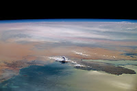 Towering cumulus clouds rise above the Arabian peninsula.