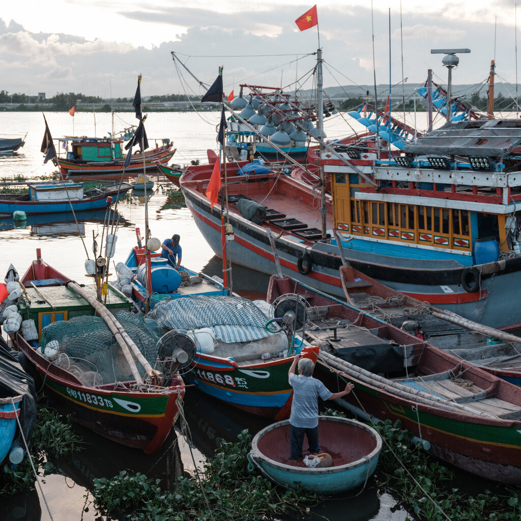 Fisherman and fishing boats at a Vietnamese port. 